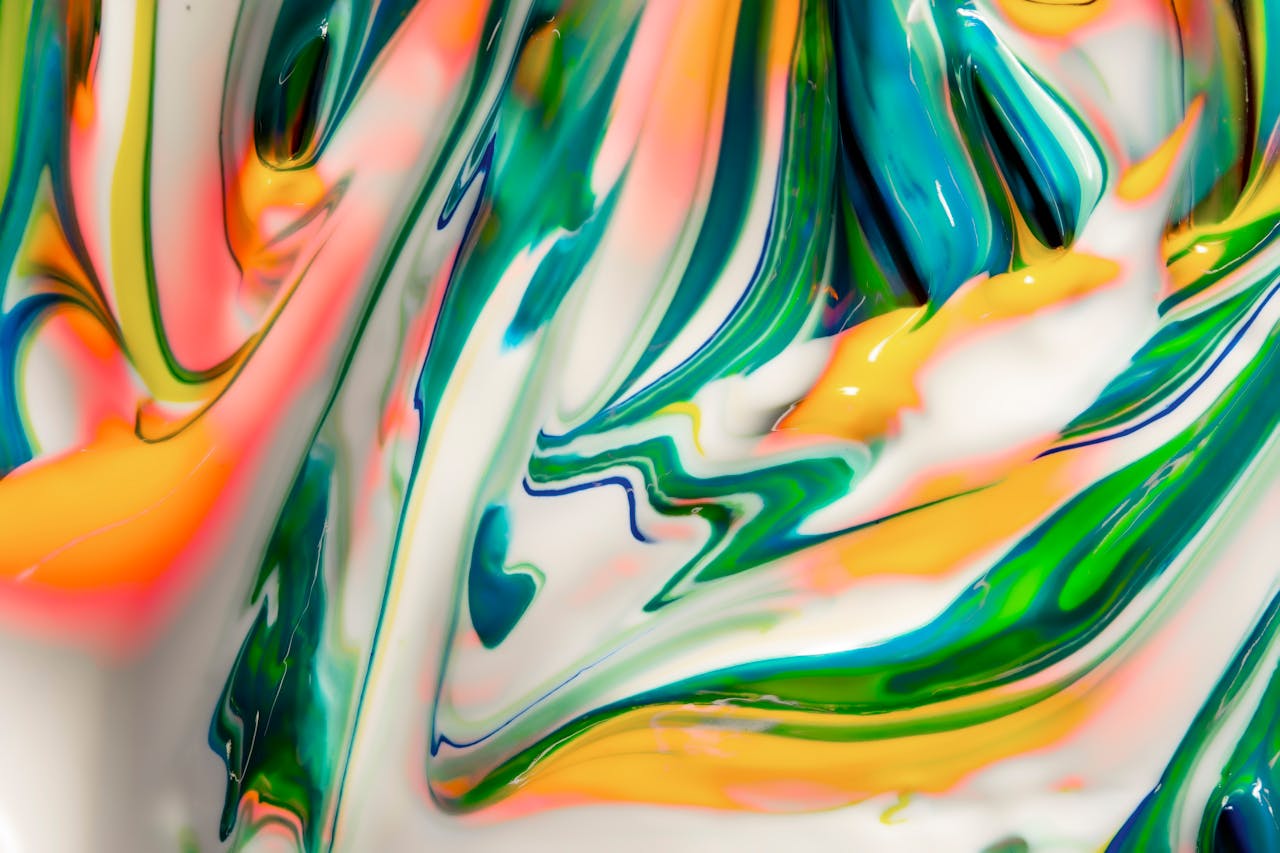 Dynamic abstract image featuring vibrant swirls of mixed colors in an artistic blend.
